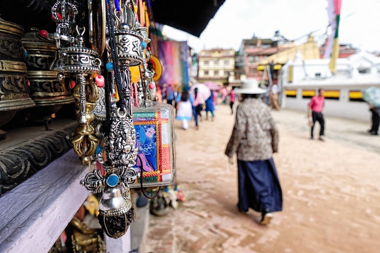 woman waking away front the colourful hanging decor