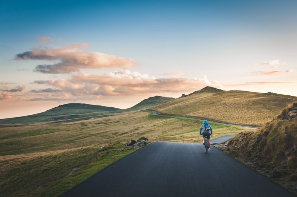 a man on cycle in the countryside
