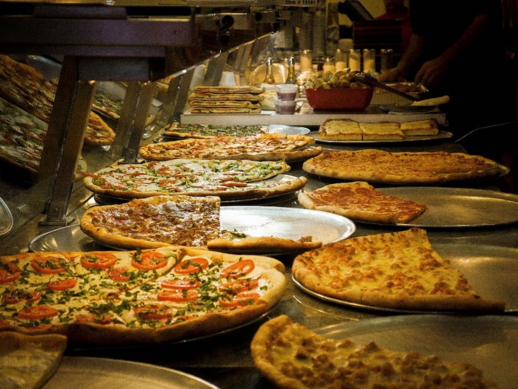 Different types of pizza ready to be served at a restaurant in New York City