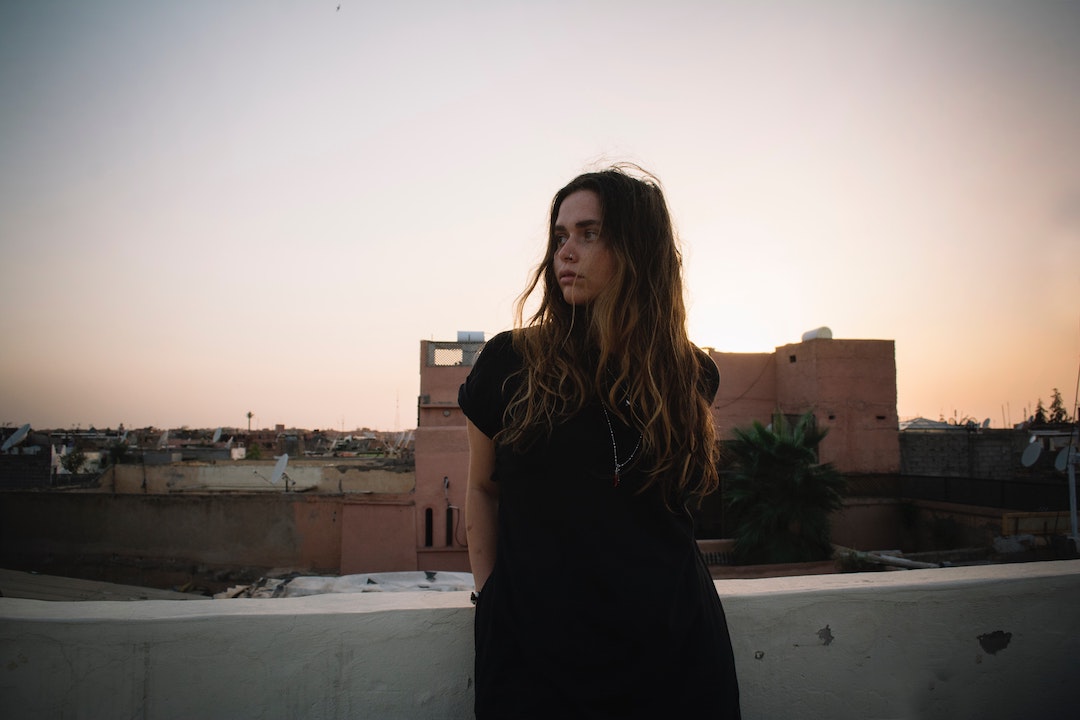 Woman looking to the right with Morocco scenery in the background