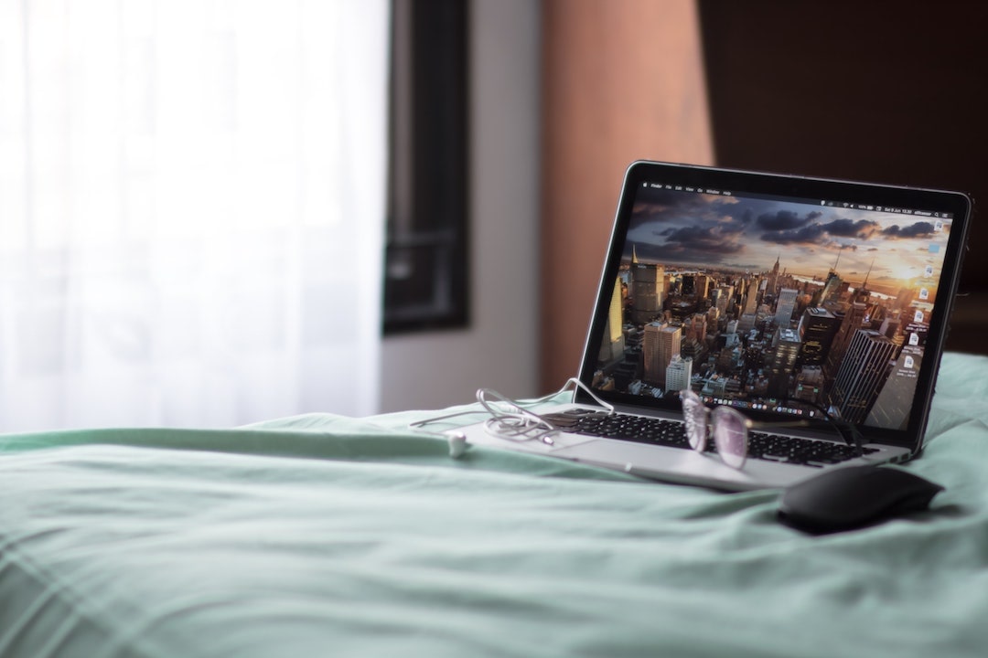 Laptop sitting on table with New York City screensaver