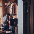 man and woman standing in front of gas range