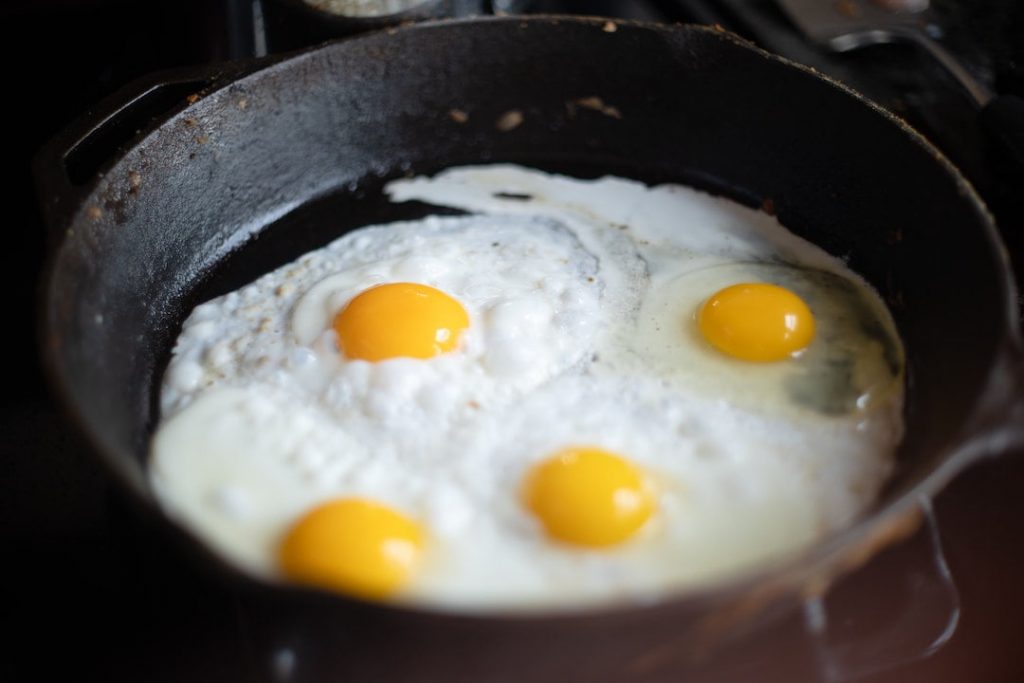 Four fried eggs in a skillet pan