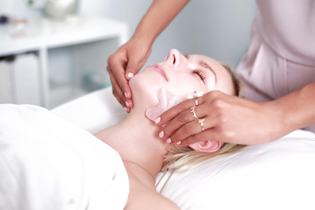 beauty rituals from around the world: a woman performs facial gua sha