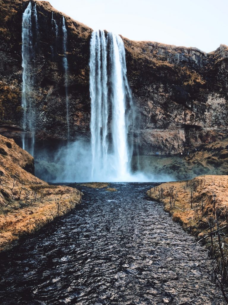 Waterfall flowing into a stream in Iceland