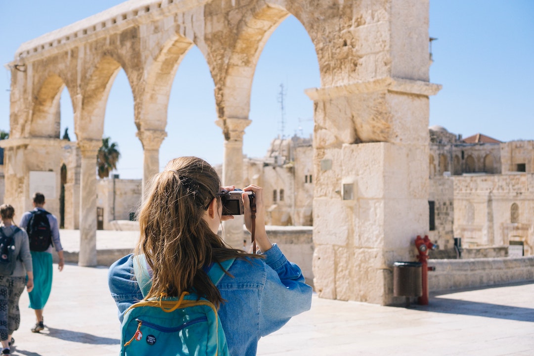 Woman taking a picture of ruins