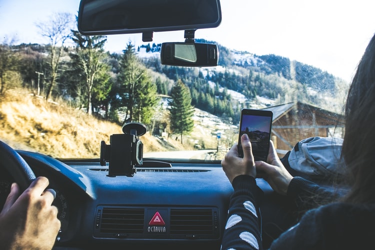 person taking a picture from the car