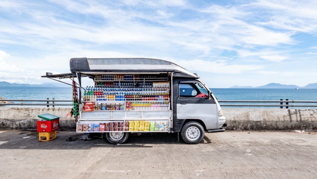 A portable kiosk selling beverages in plastic bottles