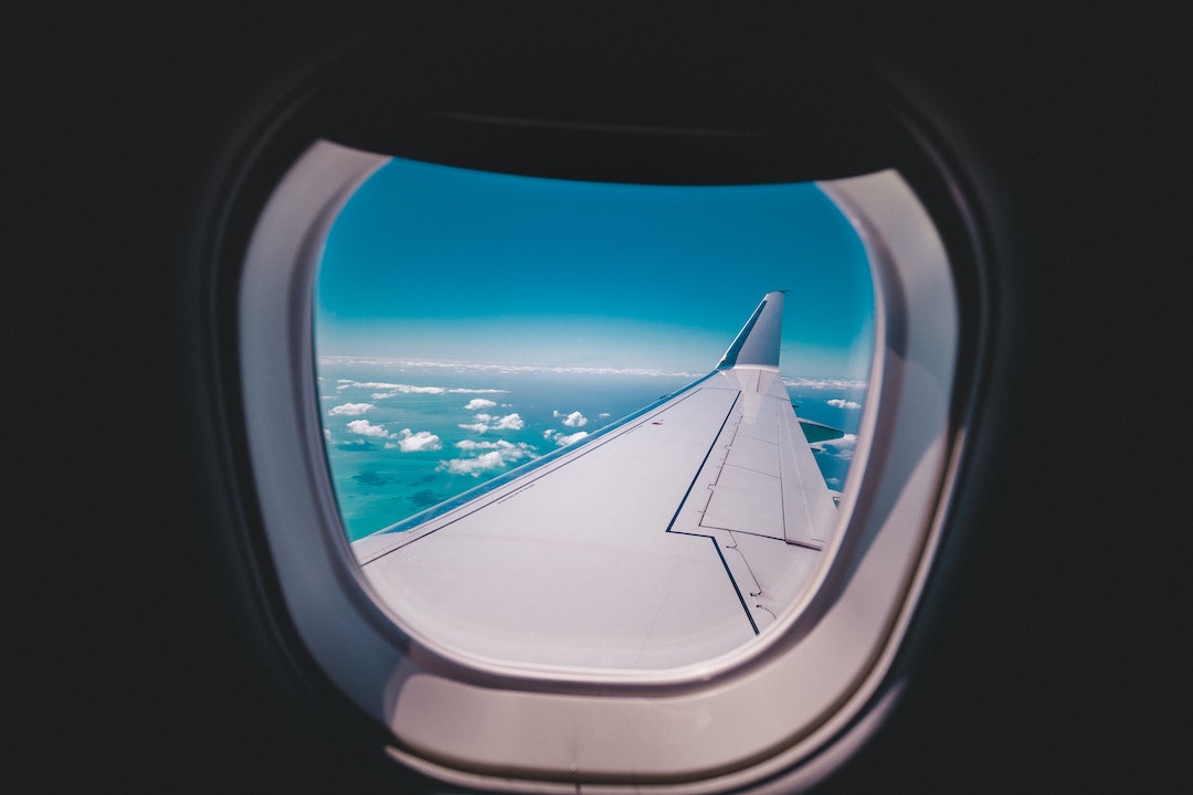 Airplane wing view out of plane window
