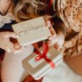 Two friends exchanging holiday gifts
