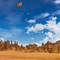 Hot air balloons flying in the blue sky of AlUla, Saudi Arabia